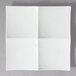 A white square porcelain tapas tray with four sections.