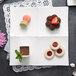 A white 10 Strawberry Street tapas tray with cookies and desserts on it.