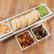 A 10 Strawberry Street Whittier rectangular tray with dishes of snacks and dips including crackers, olives and green dip.
