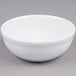 A Tuxton bright white china nappie bowl on a gray surface.