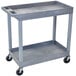 A grey Luxor plastic utility cart with two shelves and wheels.