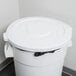 A white Continental round trash can lid on a white trash can.