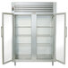 A Traulsen white refrigerator with glass doors and shelves.