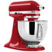 A red KitchenAid Artisan stand mixer with a bowl attached.
