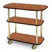 A Geneva rectangular wood serving cart with three tiers on wheels.