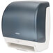 A navy blue Bobrick surface-mounted roll paper towel dispenser.