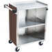A stainless steel utility cart with a wood shelf and enclosed base.