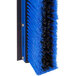 A blue and black Carlisle commercial push broom.
