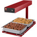 A red Hatco food warmer with two trays of meatballs and chicken on a counter.