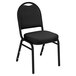 A black National Public Seating stack chair with a black metal frame and cushion.
