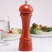 A Chef Specialties butternut orange pepper mill on a table.