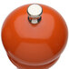A close-up of a Chef Specialties Butternut Orange pepper mill with a metal knob.