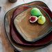 A TuxTrendz Artisan Mojave square china plate with figs on it.