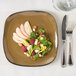 A Tuxton Artisan Mojave square china plate with salad and fruit on it.