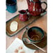 A table set with Tuxton TuxTrendz Artisan Night Sky mugs, a teapot, and a spoon.