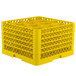 A yellow plastic Vollrath Traex glass rack with open extender on top and 12 compartments.