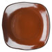 A brown square plate with a white rim.