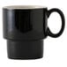 A black Tuxton china mug with a white handle.
