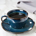 A blue cup of coffee on a TuxTrendz Night Sky china saucer.