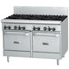 A large white Garland commercial gas range with black knobs and two ovens.