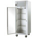 A Traulsen G Series reach-in refrigerator with a left-hinged glass door open.