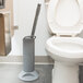 A white toilet with Unger Ergo Toilet Bowl Swab in the back.