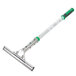 An Unger griddle cleaner with a green and silver metal mop.