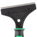 A Unger ErgoTec grill scraper with a black and green handle.