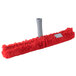 A red mop with a white plastic T-bar handle.