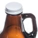 A brown glass growler with a white Libbey replacement cap.