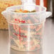 A close-up of a Cambro translucent plastic container with pasta inside.
