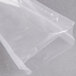 A clear plastic bag of ARY VacMaster Cook-In Chamber Re-Therm Vacuum Packaging Bags on a grey surface.