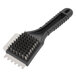 A black Waring grill brush with bristles and a handle.