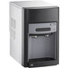 A black and white Follett countertop ice maker and water dispenser.