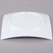 A white Thunder Group square melamine plate with a curved edge.