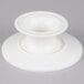 An American Metalcraft white porcelain serving stand with a round base on a white surface.