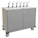 A stainless steel Lakeside serving cart with eight metal condiment pumps.