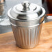An American Metalcraft mini stainless steel trash can lid on a silver container.