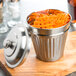 An American Metalcraft stainless steel mini round trash can filled with french fries.