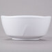 A close-up of a Thunder Group Classic White melamine round bowl with a small handle.