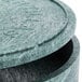 A close up of a round green polyethylene tortilla container with a lid.