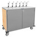 A stainless steel Lakeside serving cart with eight metal pumps.