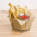 A basket of french fries with ketchup on the side.