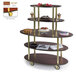 A Geneva oval dessert cart with three wooden oval shelves holding cakes.