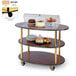 A Geneva three tier serving cart with a plate of food under a glass dome.