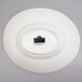 A white oval porcelain bowl with the words "Whittier" in black.