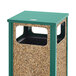 A Rubbermaid green and brown square trash can with a green lid on a table outdoors.