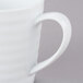 A close-up of a white 10 Strawberry Street Swing porcelain mug with a C-handle.