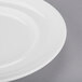 An Arcoroc white porcelain salad/dessert plate with a rim.