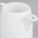 An Arcoroc white large creamer with a handle.